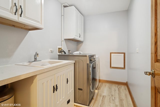 26464 N Bittersweet Trl, Mundelein, IL 60060 - laundry room featuring washer and clothes dryer, cabinet space, light wood-style floors, and baseboards