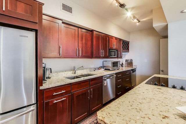 3180 N Lake Shore Dr Unit 4F, Chicago, IL 60657 - kitchen featuring appliances with stainless steel finishes, a sink, rail lighting, dark brown cabinets, and light stone counters