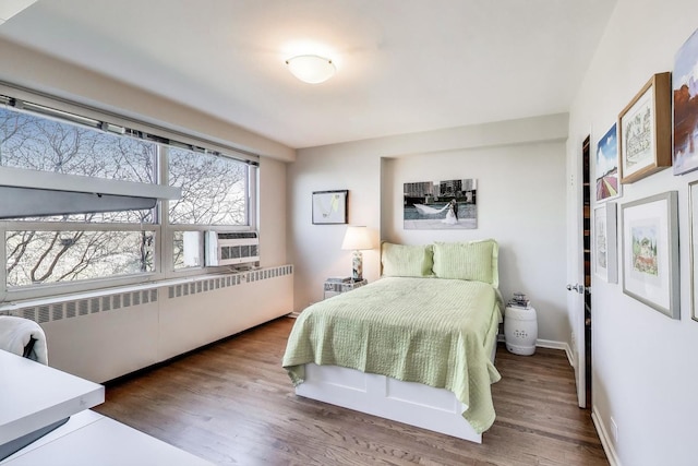 3180 N Lake Shore Dr Unit 4F, Chicago, IL 60657 - bedroom featuring radiator, wood finished floors, cooling unit, and baseboards