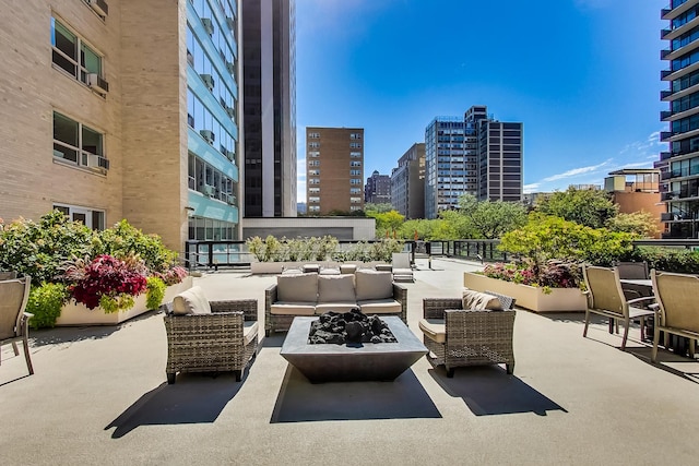 3180 N Lake Shore Dr Unit 4F, Chicago, IL 60657 - view of patio with an outdoor living space with a fire pit and a city view