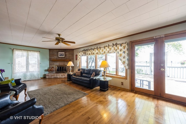 3714 W Lake Shore Dr, Wonder Lake, IL 60097 - living area featuring ceiling fan, crown molding, a glass covered fireplace, french doors, and hardwood / wood-style floors