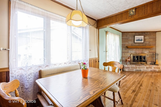 3714 W Lake Shore Dr, Wonder Lake, IL 60097 - dining room with crown molding, wood finished floors, a wainscoted wall, a fireplace, and wood walls
