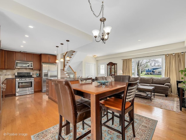 504 S Pierce Ave, Wheaton, IL 60187 - dining room featuring healthy amount of natural light, light wood finished floors, stairway, a chandelier, and recessed lighting