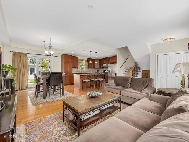 504 S Pierce Ave, Wheaton, IL 60187 - living room with a chandelier, light wood-type flooring, and stairway