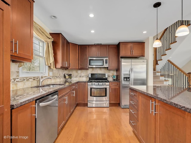 504 S Pierce Ave, Wheaton, IL 60187 - kitchen with stainless steel appliances, light wood finished floors, dark stone countertops, brown cabinetry, and recessed lighting