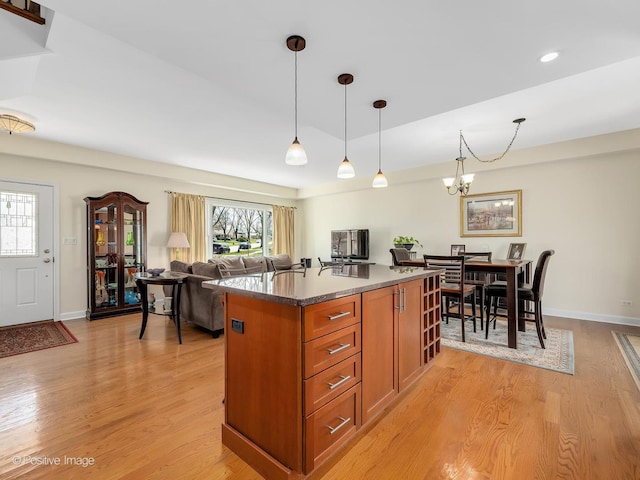 504 S Pierce Ave, Wheaton, IL 60187 - kitchen featuring brown cabinets, a chandelier, light wood-style floors, decorative light fixtures, and recessed lighting