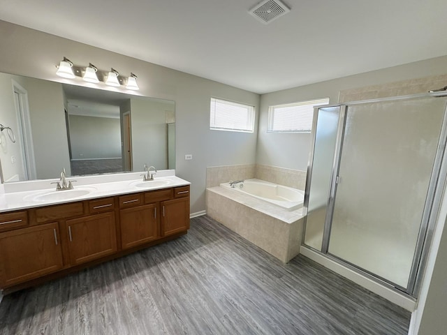 6604 Pasture Side Trl, Matteson, IL 60443 - bathroom with visible vents, a bath, a sink, double vanity, and wood finished floors