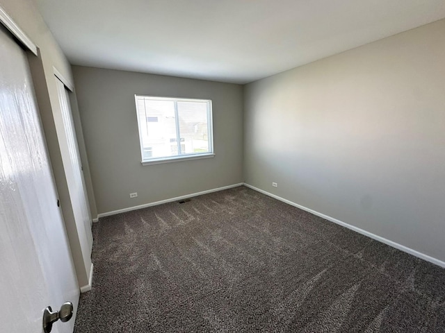 6604 Pasture Side Trl, Matteson, IL 60443 - unfurnished bedroom with baseboards, dark carpet, and visible vents