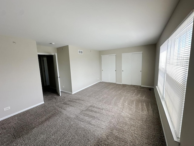 6604 Pasture Side Trl, Matteson, IL 60443 - unfurnished bedroom with multiple closets, carpet floors, baseboards, and visible vents