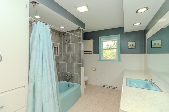 bathroom featuring tile walls, tile patterned flooring, toilet, shower / bath combo, and vanity