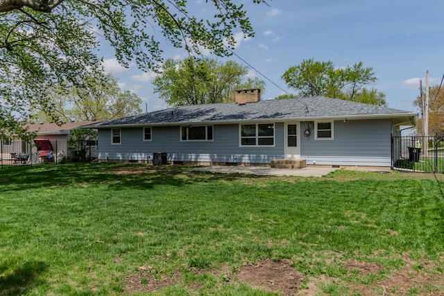 rear view of property with a chimney and a patio area