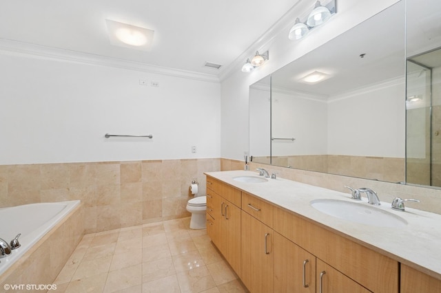 full bathroom featuring a sink, tile walls, toilet, ornamental molding, and tiled bath