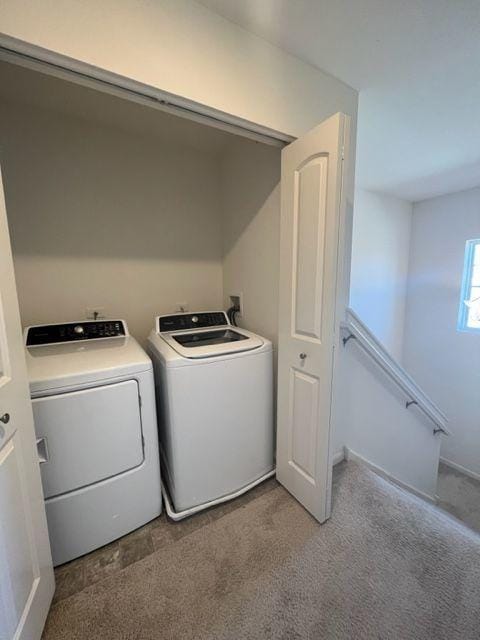 laundry room with washing machine and clothes dryer, laundry area, and carpet floors
