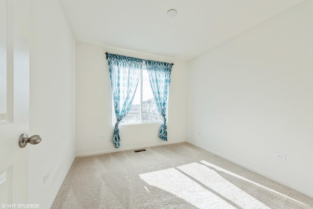 carpeted empty room with visible vents and baseboards