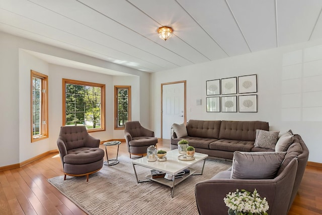 living area with baseboards and wood finished floors