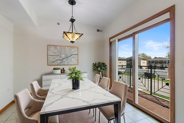 dining area featuring light tile patterned floors and baseboards