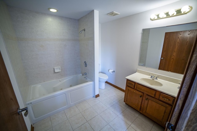 bathroom featuring toilet, tile patterned flooring, vanity, a combined bath / shower with jetted tub, and baseboards