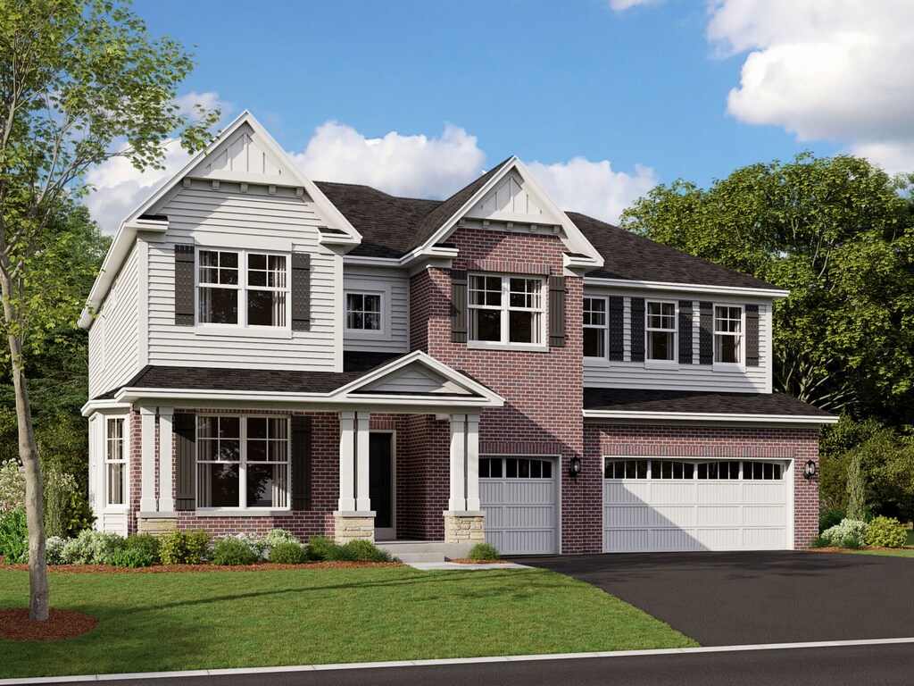 craftsman inspired home with a front lawn, brick siding, an attached garage, and aphalt driveway
