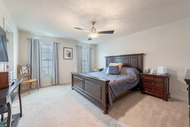 bedroom with ceiling fan, light carpet, baseboards, and visible vents