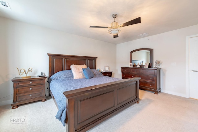 bedroom with baseboards, a ceiling fan, visible vents, and light colored carpet