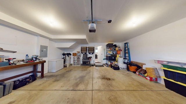 garage featuring electric panel, a garage door opener, and fridge