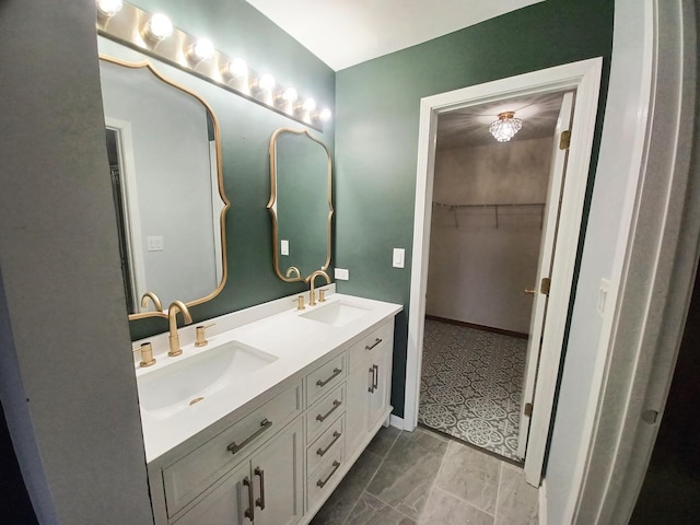 full bath with double vanity and a spacious closet
