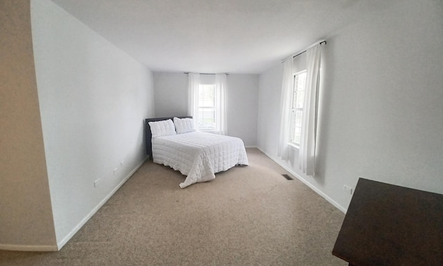 bedroom featuring carpet and baseboards