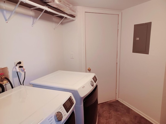 clothes washing area featuring electric panel, separate washer and dryer, dark tile patterned flooring, and baseboards
