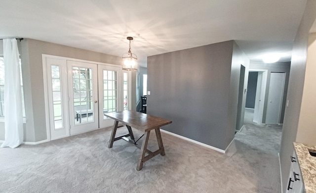 dining area featuring french doors, carpet, and baseboards