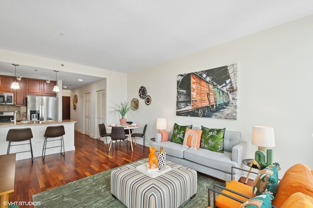 living area featuring dark wood-style floors, baseboards, and recessed lighting