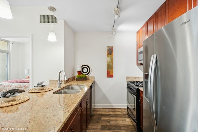 kitchen with stainless steel fridge with ice dispenser, a sink, gas stove, dark wood-style flooring, and light stone counters