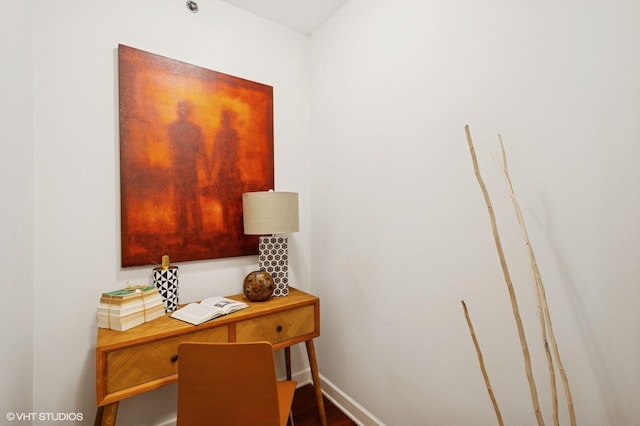 office featuring baseboards and wood finished floors