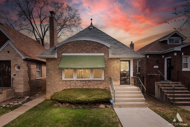 10041 S Calumet Ave, Chicago, IL 60628 - bungalow-style house with brick siding and a chimney