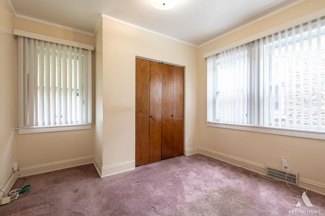 10041 S Calumet Ave, Chicago, IL 60628 - unfurnished bedroom featuring crown molding, a closet, carpet floors, and baseboards