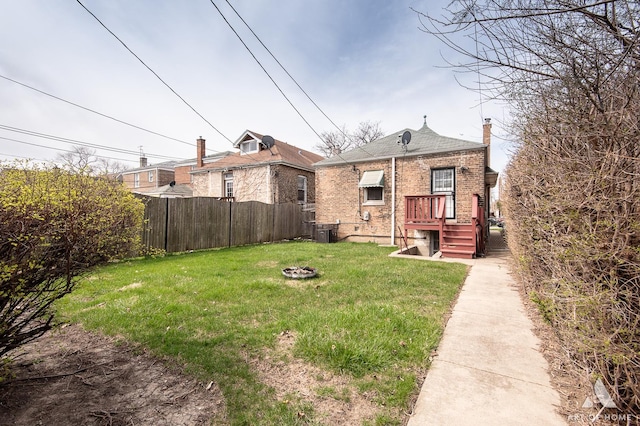 10041 S Calumet Ave, Chicago, IL 60628 - rear view of property with a chimney, central AC, and brick siding