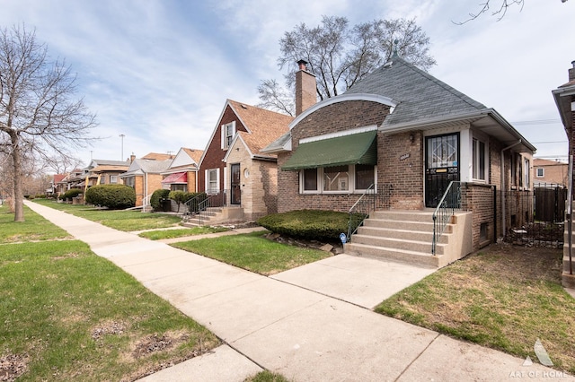 10041 S Calumet Ave, Chicago, IL 60628 - view of front of property with brick siding, a front lawn, a chimney, a residential view, and central AC unit