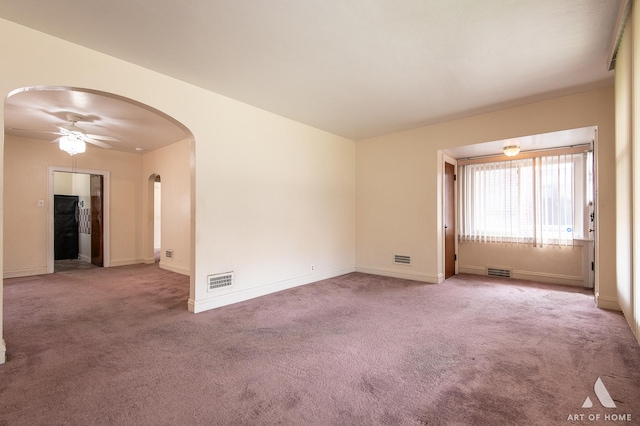 10041 S Calumet Ave, Chicago, IL 60628 - spare room featuring arched walkways, ceiling fan, carpet floors, and baseboards