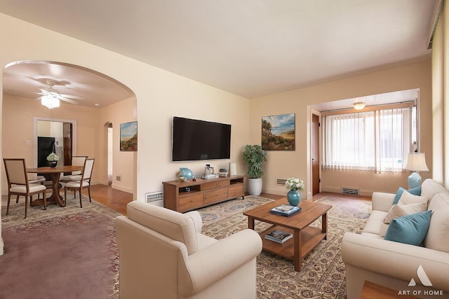 10041 S Calumet Ave, Chicago, IL 60628 - living room with arched walkways, baseboards, a ceiling fan, and wood finished floors