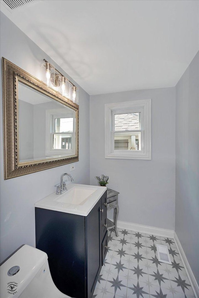 3530 S Union Ave, Chicago, IL 60609 - half bath featuring tile patterned floors, plenty of natural light, baseboards, and vanity