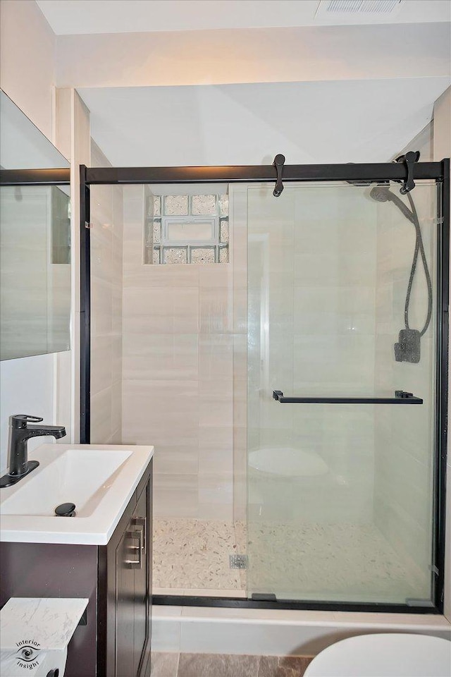 3530 S Union Ave, Chicago, IL 60609 - bathroom with a stall shower, visible vents, vanity, and toilet