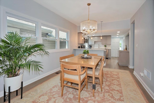 3530 S Union Ave, Chicago, IL 60609 - dining area with plenty of natural light, light wood-style floors, a chandelier, and baseboards