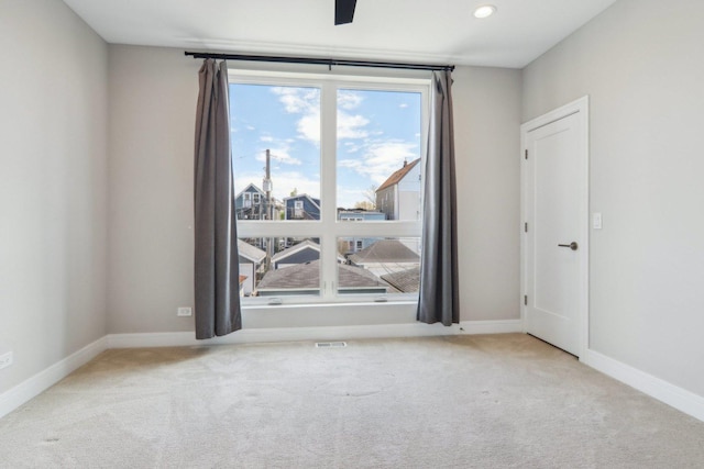 spare room featuring carpet flooring and baseboards