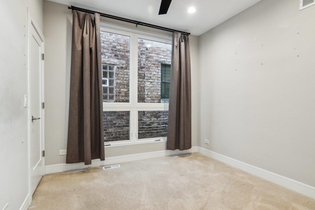 empty room featuring carpet floors, baseboards, and recessed lighting