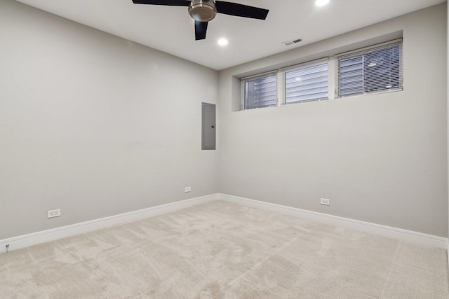 carpeted spare room featuring ceiling fan, baseboards, recessed lighting, and electric panel