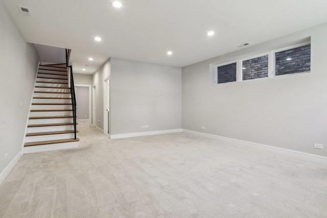 finished basement featuring recessed lighting, stairway, baseboards, and light colored carpet