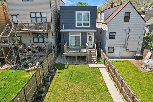 rear view of property with stairs and a wooden deck