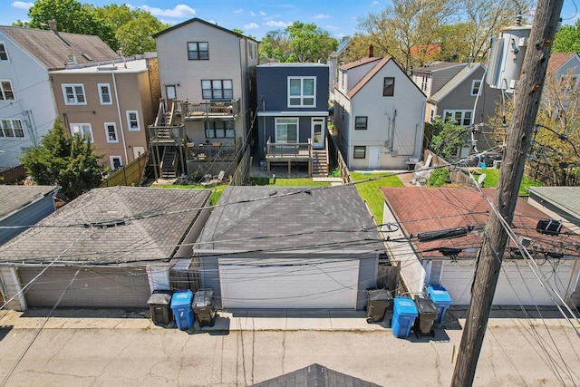 back of property with a residential view and fence