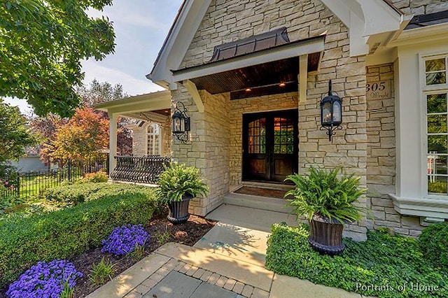 305 S Wright St, Naperville, IL 60540 - entrance to property featuring stone siding, covered porch, and fence