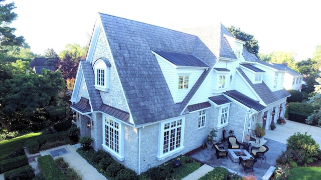 305 S Wright St, Naperville, IL 60540 - rear view of house featuring an attached garage, concrete driveway, a patio, metal roof, and a standing seam roof