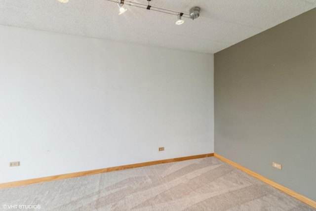 9701 N Dee Rd Unit 4C, Niles, IL 60714 - carpeted empty room featuring baseboards and a textured ceiling